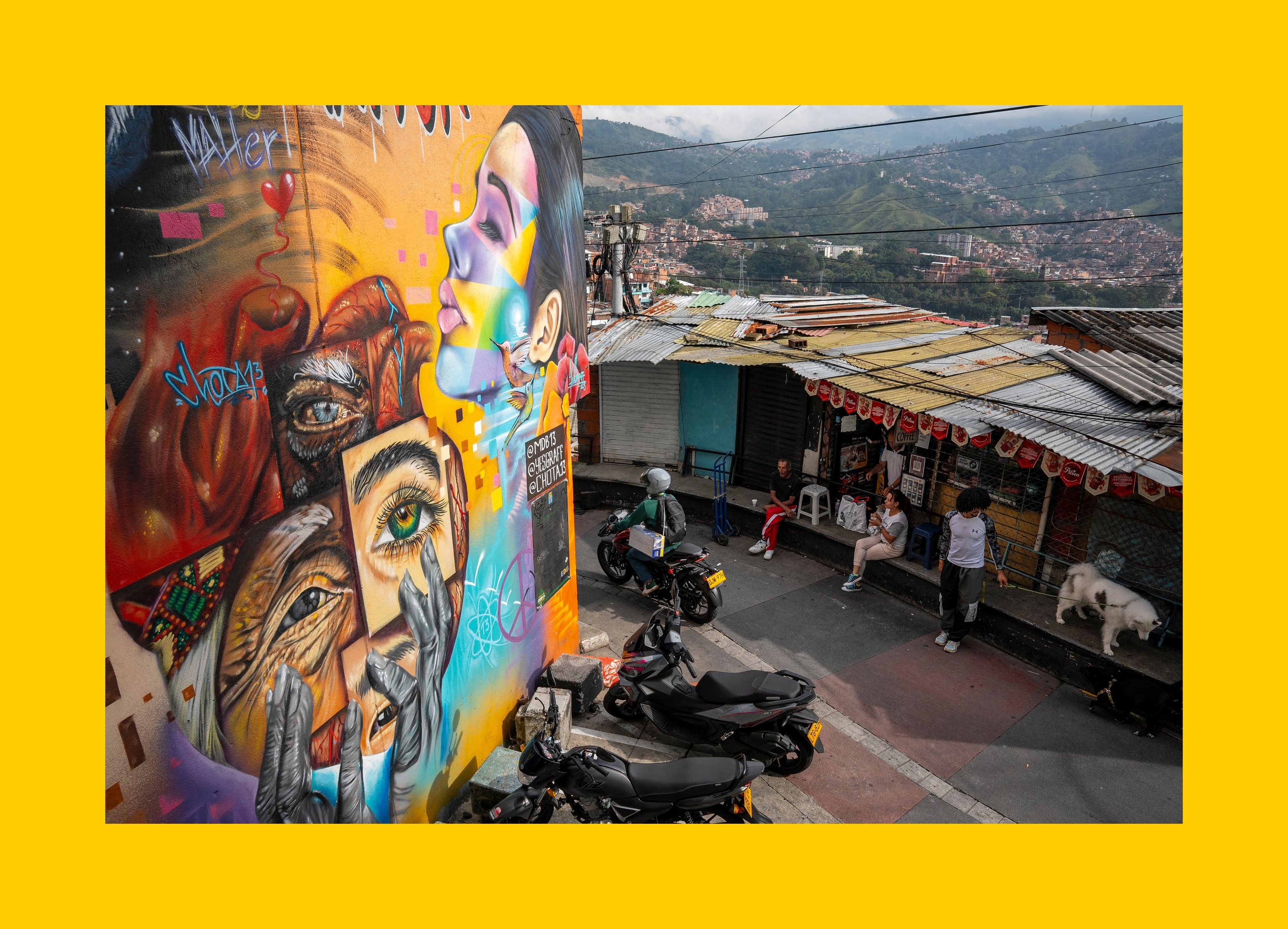 Residents of Comuna 13 of Medellín, Colombia, sit in front of a wall painting, on August 12, 2025.