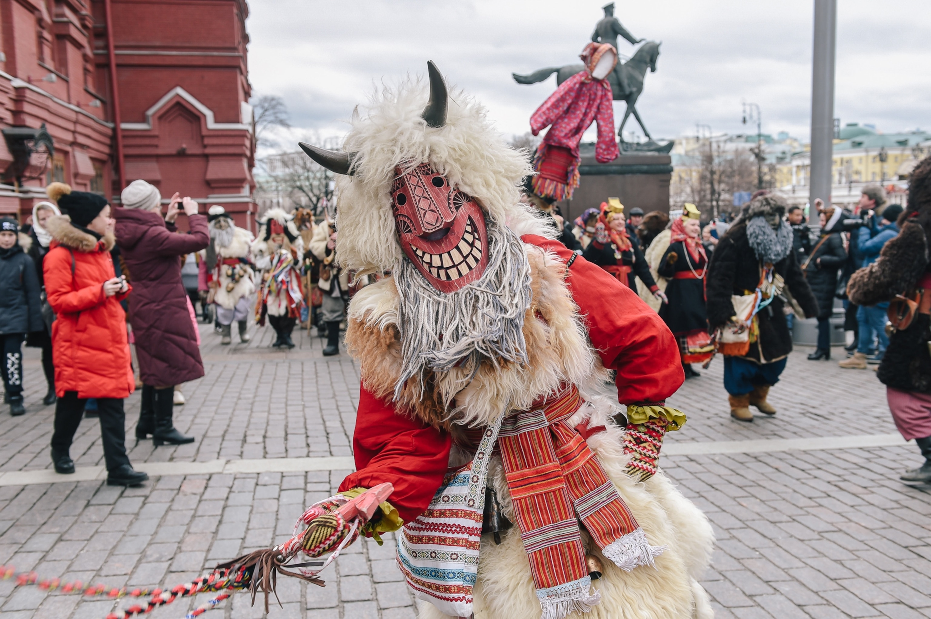 People in costumes march on Manezhnaya Square during the Maslenitsa festival celebrations in Moscow, Russia