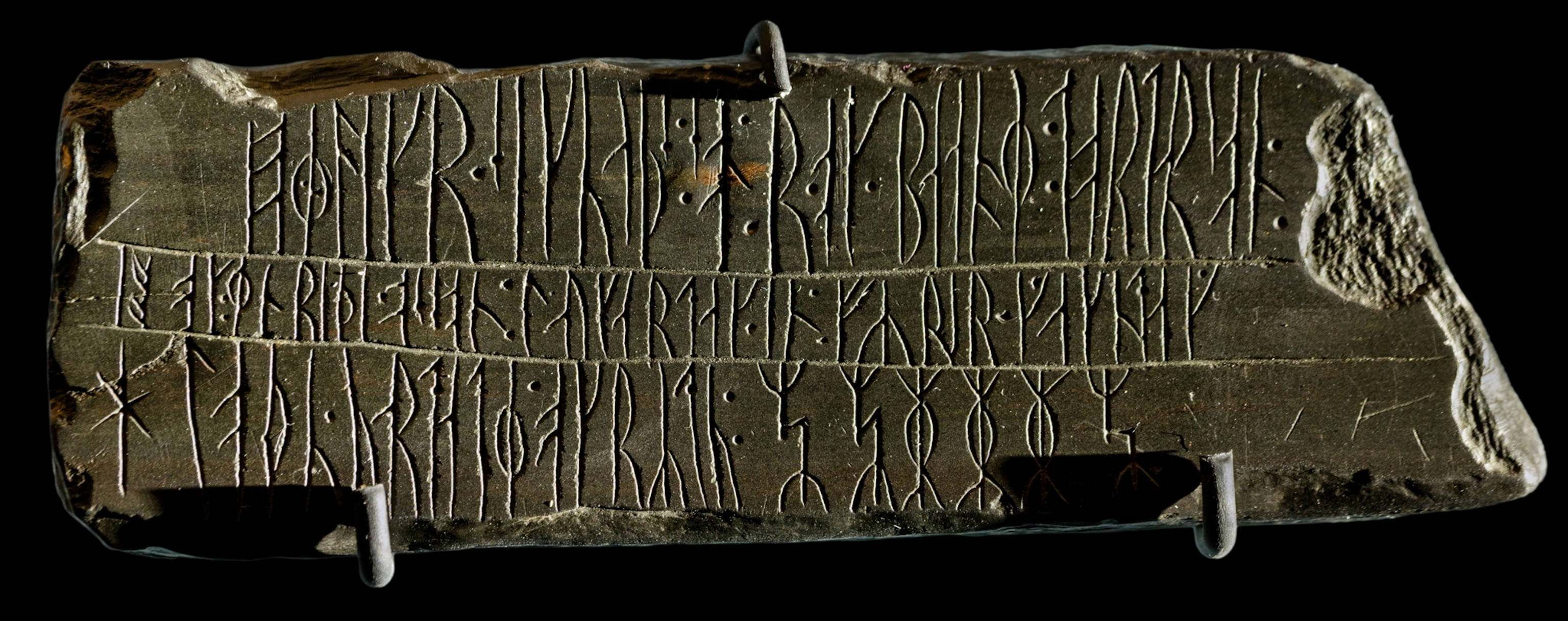 Stone tablet with beautiful letters engraved in it.