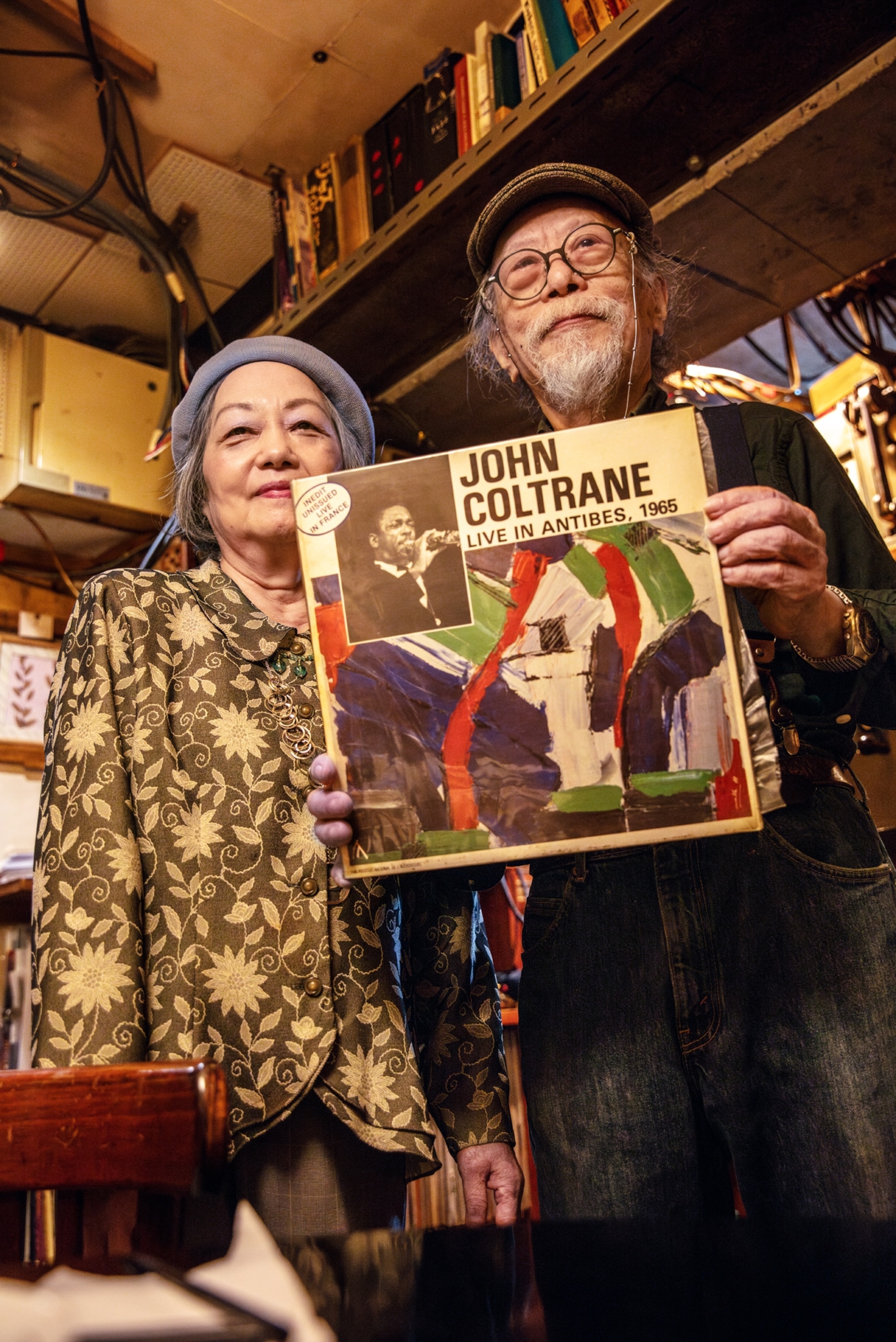 Aged man and woman holding 1965 John Coltrane record.