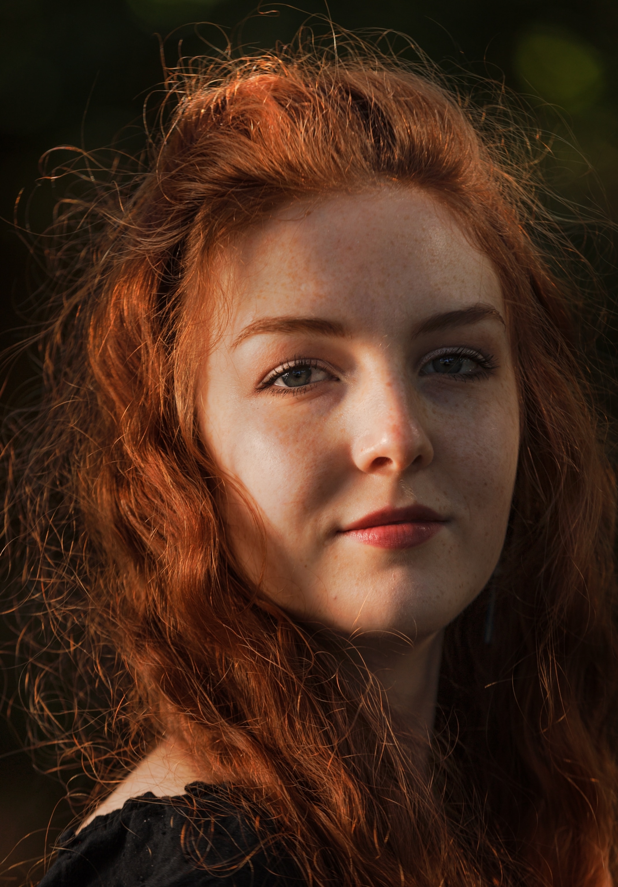 Young woman with long red curly hair.